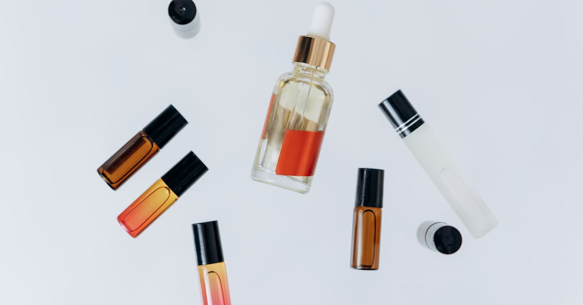 Minimalist flat lay of essential oil bottles with a pipette for beauty and wellness. perfume bottles